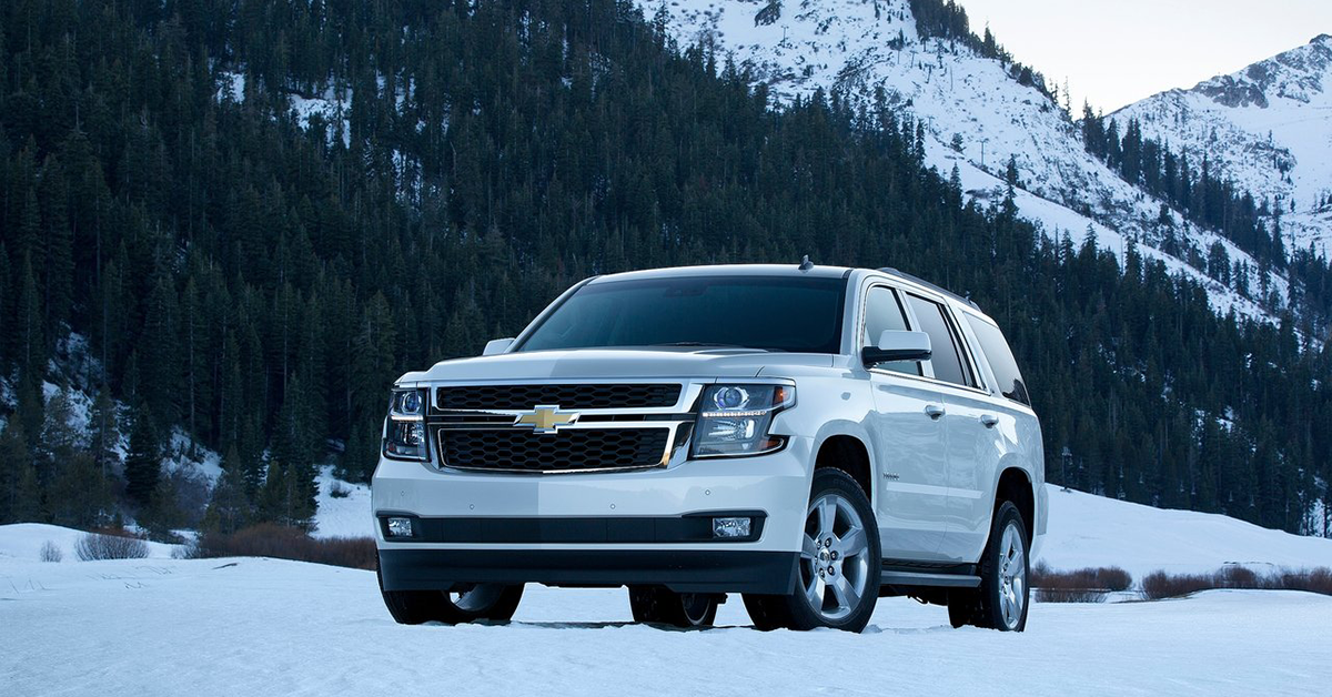 White 2015 Chevrolet Tahoe on a snowy road