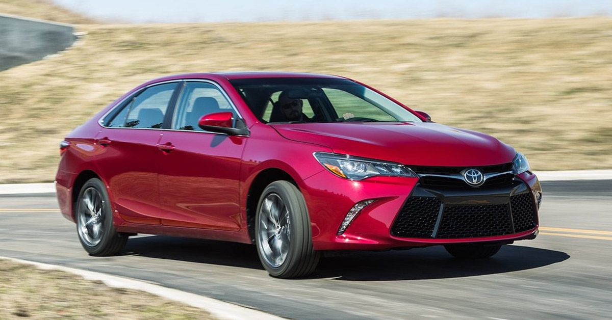 Red 2015 Toyota Camry on the road