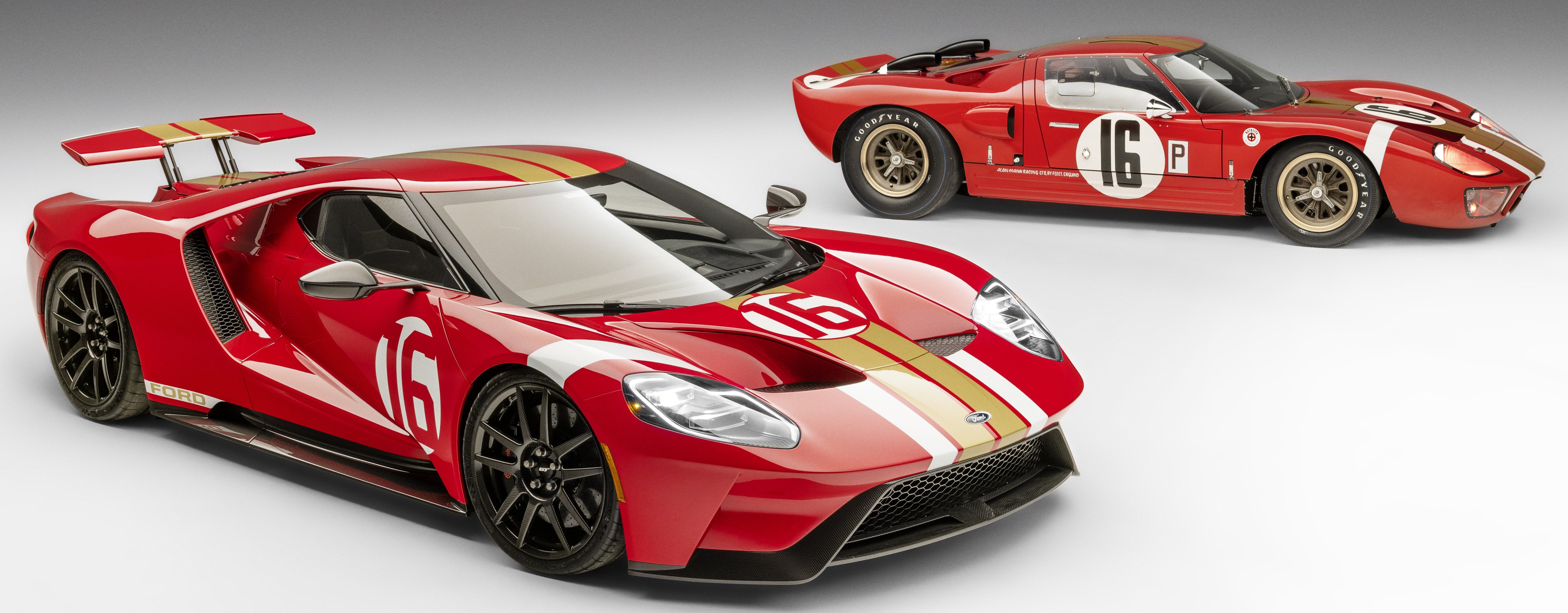 Red 2022 Ford GT Alan Mann Heritage Edition parked along with a first-generation Ford GT indoors under studio lighting 