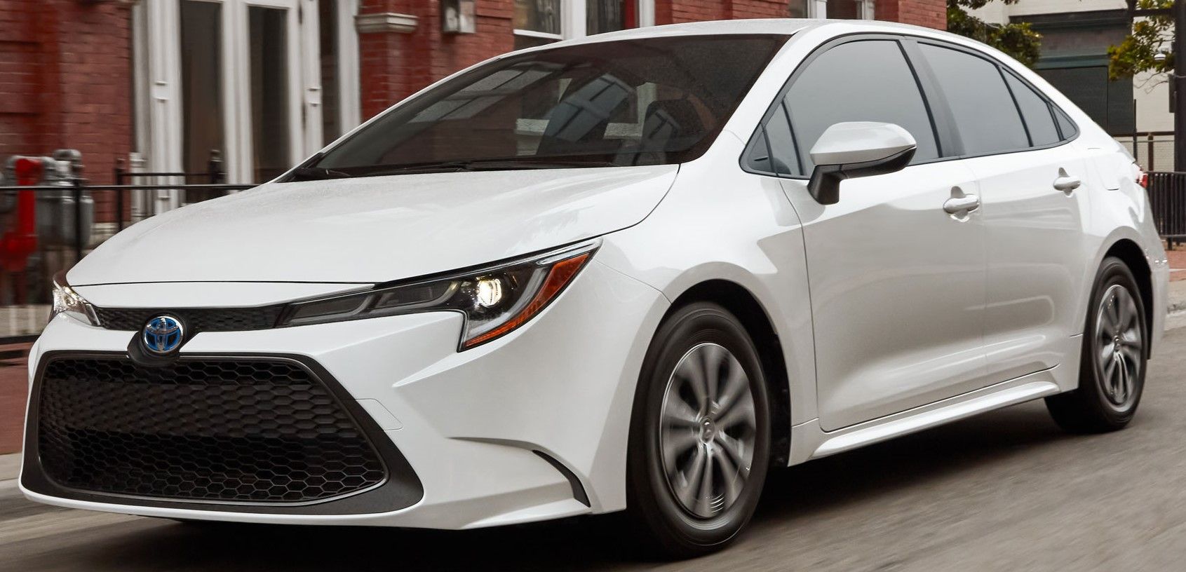 White 2022 Toyota Corolla Hybrid driven on the road