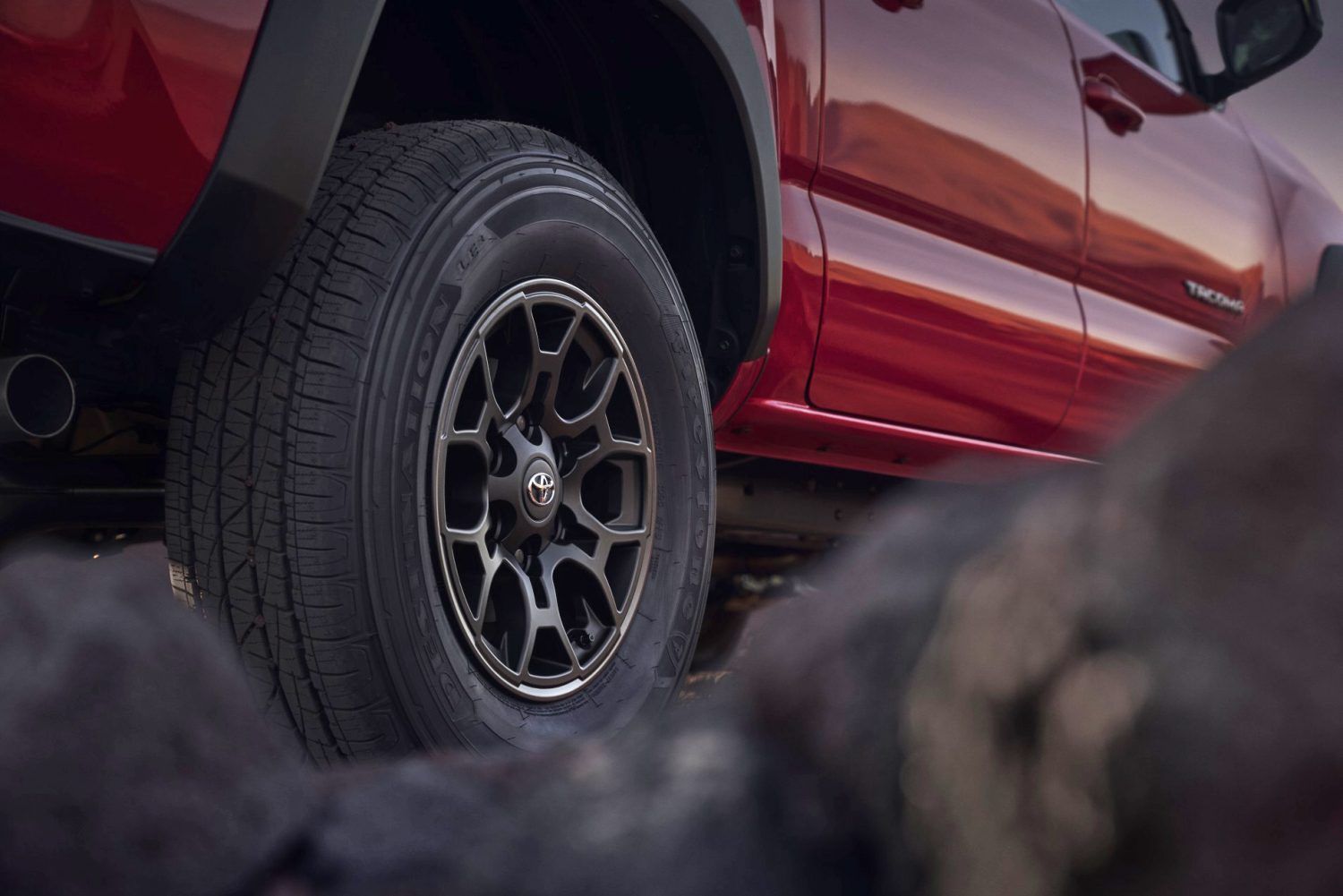 The back tire of a red 2023 Toyota Tacoma