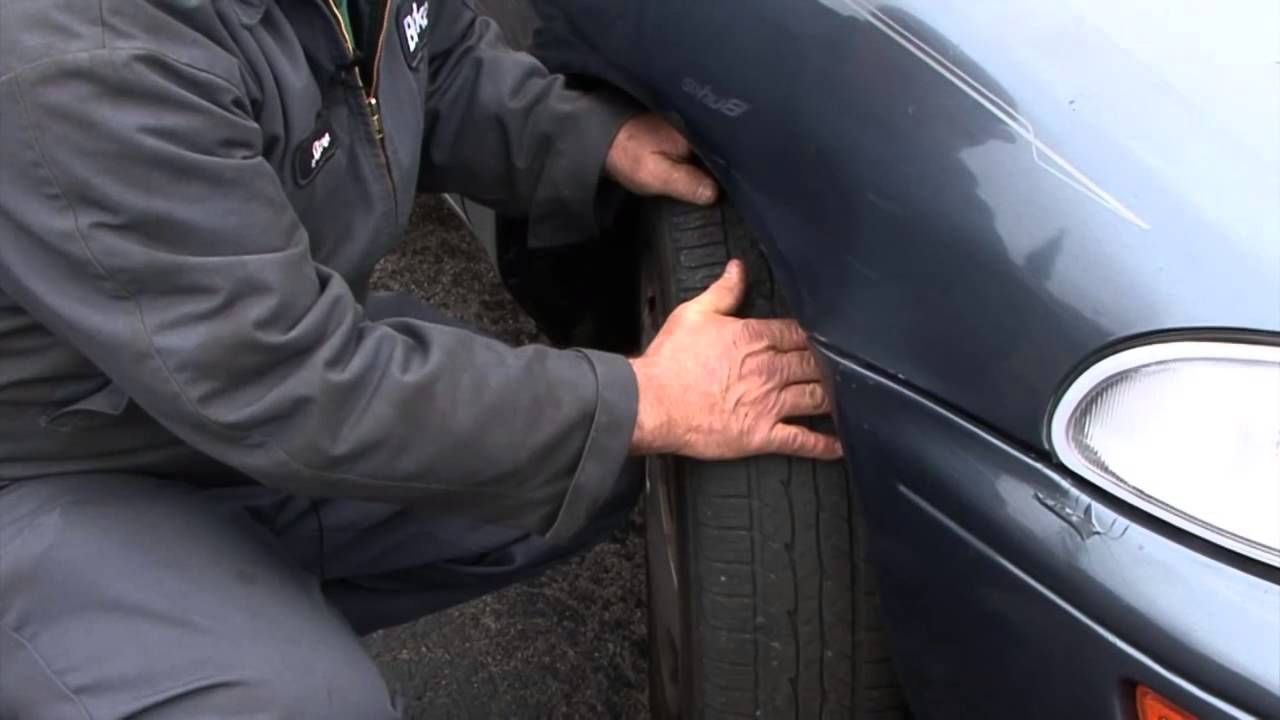 A Man Identifying Uneven Tire Wear