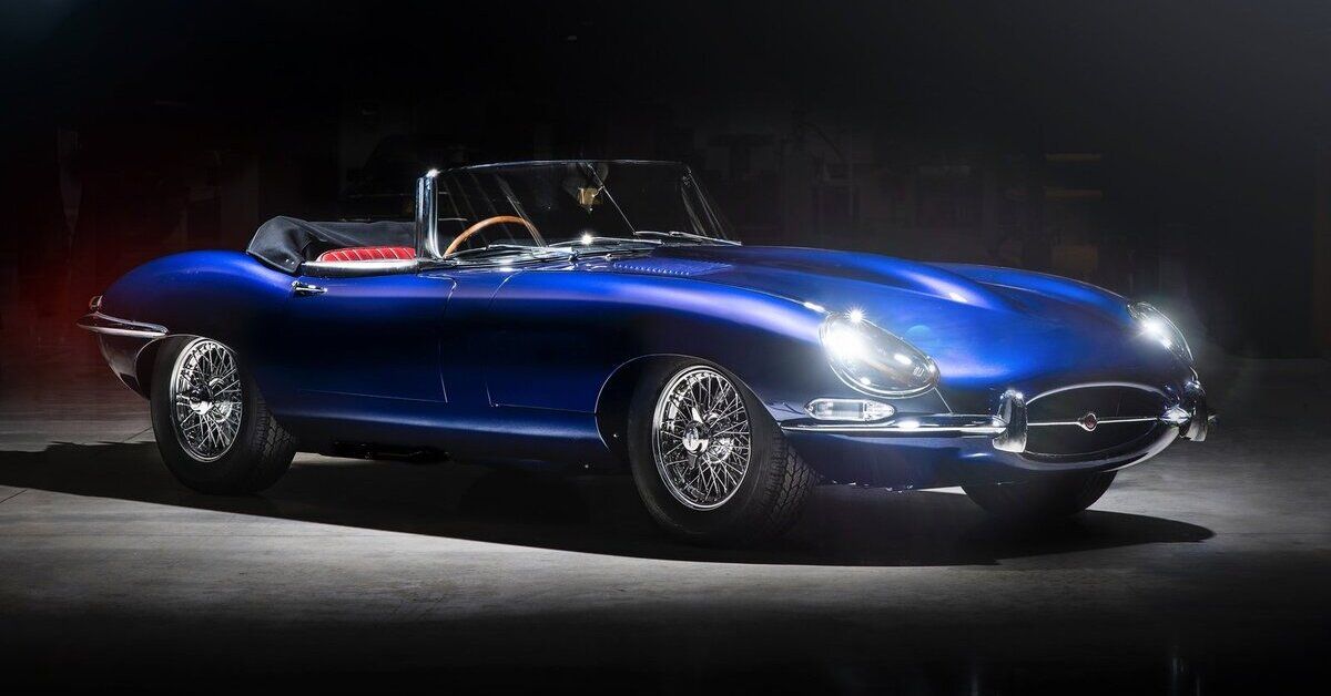 A blue 1966 Jaguar E-Type Roadster parked