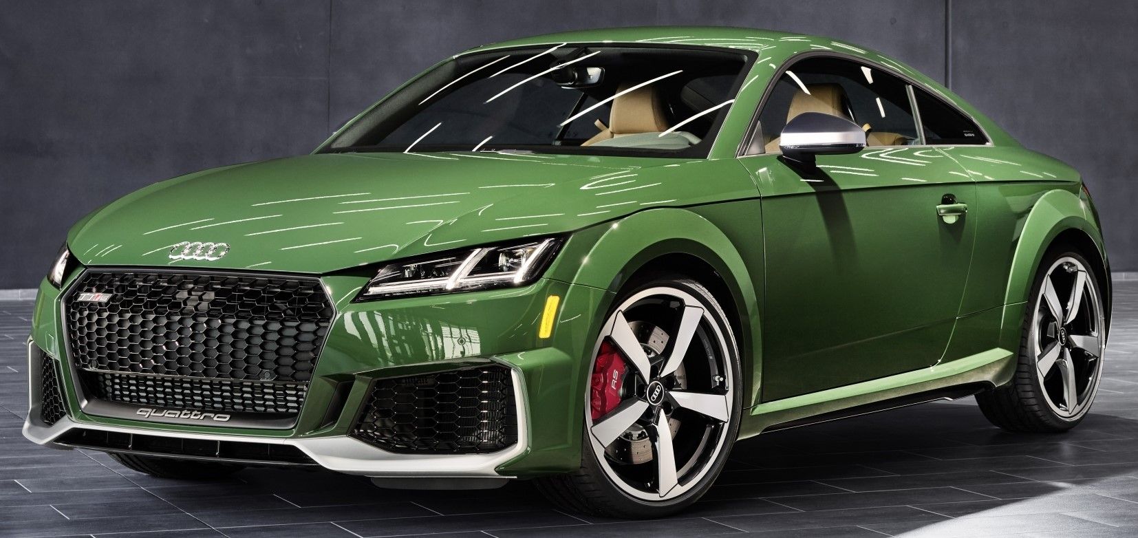 Green 2022 Audi TT RS Heritage Edition parked indoors under studio lighting