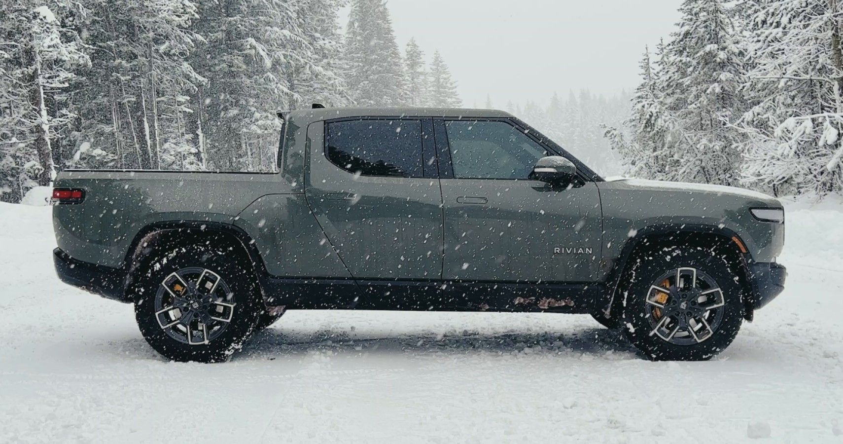 Rivian R1T in snow side view