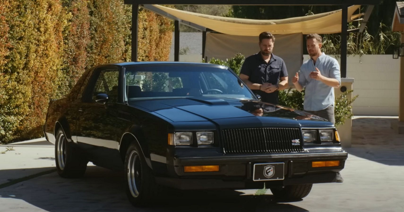 Presenters Thomas and James with a 1987 Buick GNX