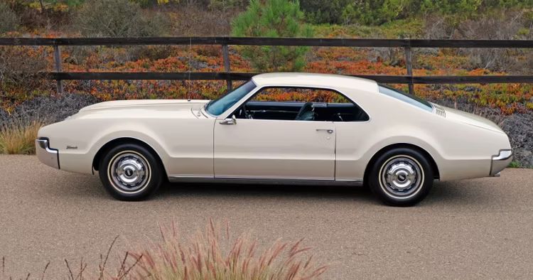 1966 oldsmobile white toronado parked 