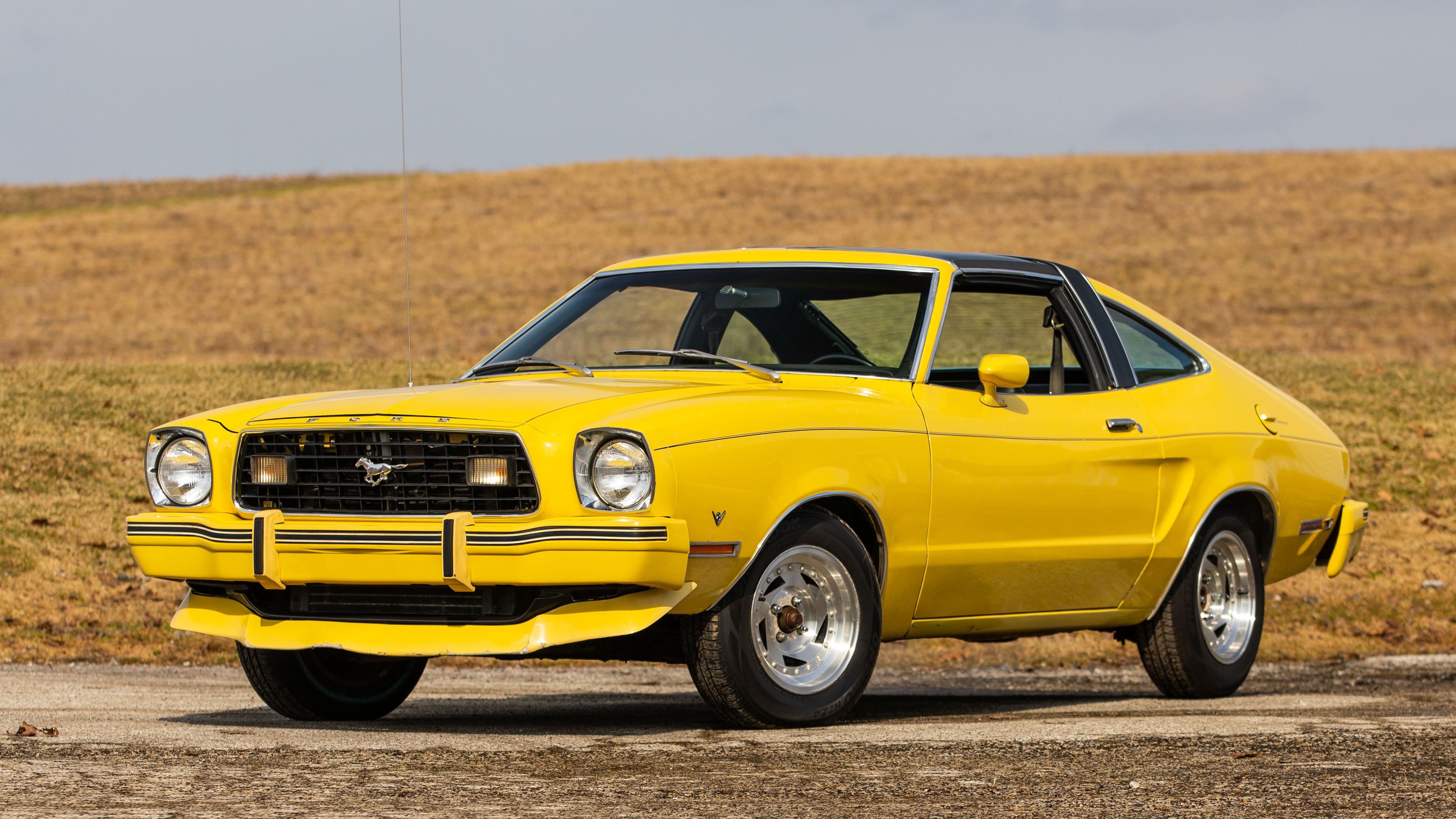 Yellow 1978 Ford Mustang II parked outside