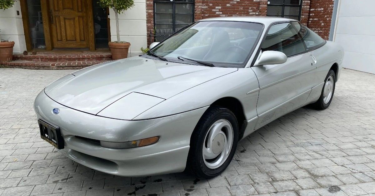 Silver 1994 Ford Probe parked outside