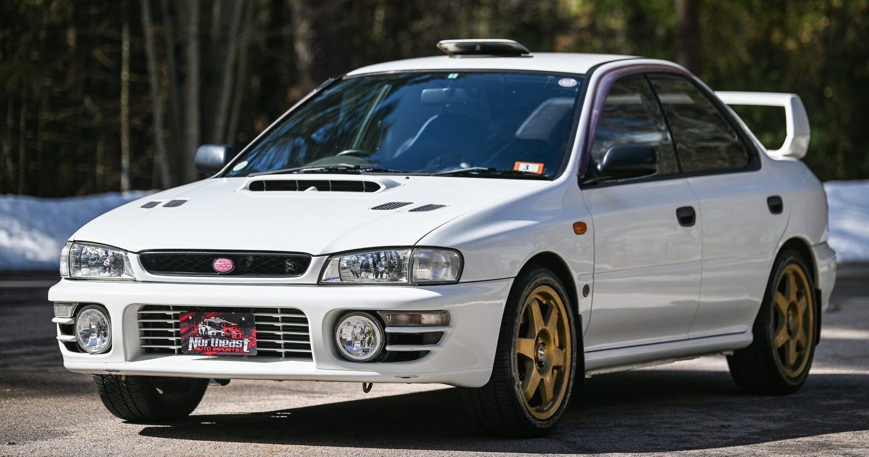 A white 1996 Subaru Impreza WRX STI parked