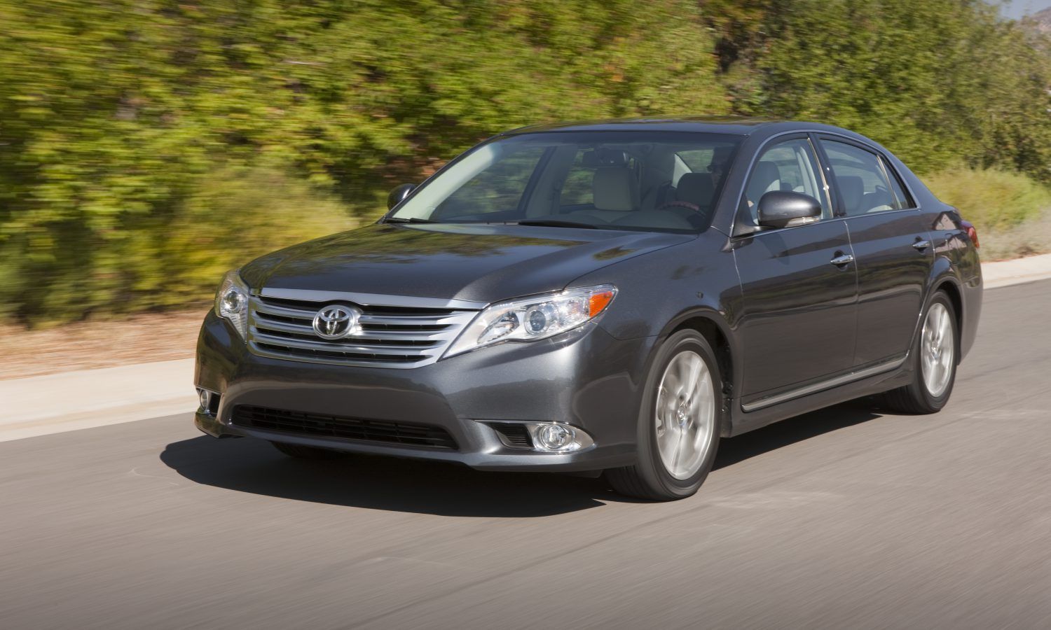 Black 2012 Toyota Avalon on the road