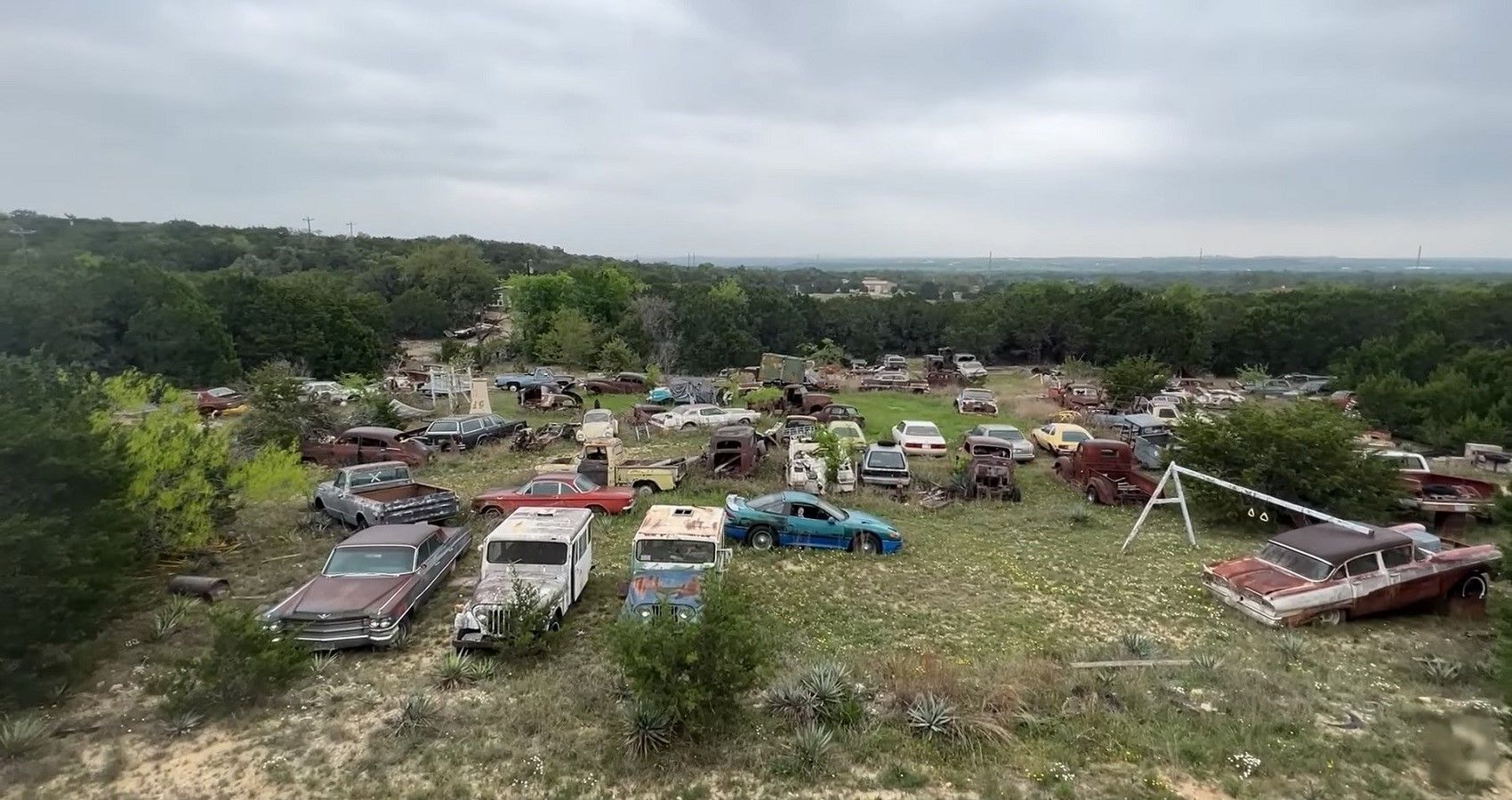 Field of classic used cars / barn finds, view of field
