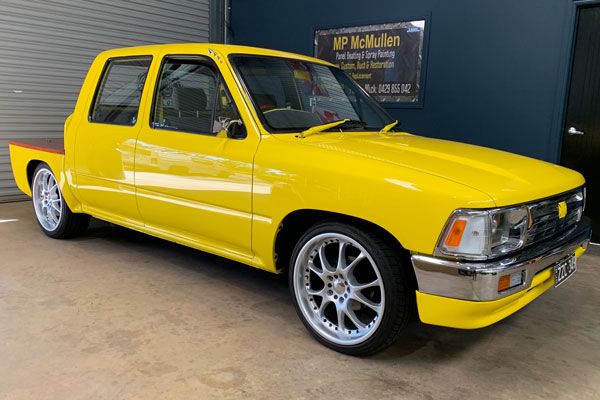 Yellow 1990 Toyota Hilux in garage