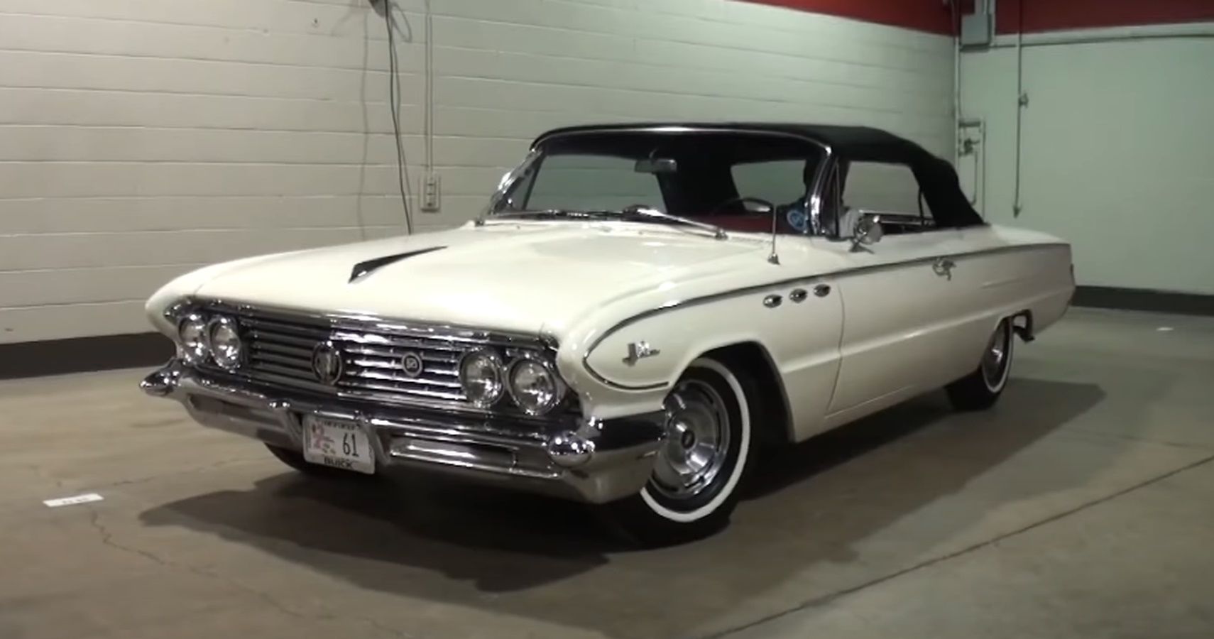 Front and side view of a white 1961 Buick LeSabre convertible with the top up