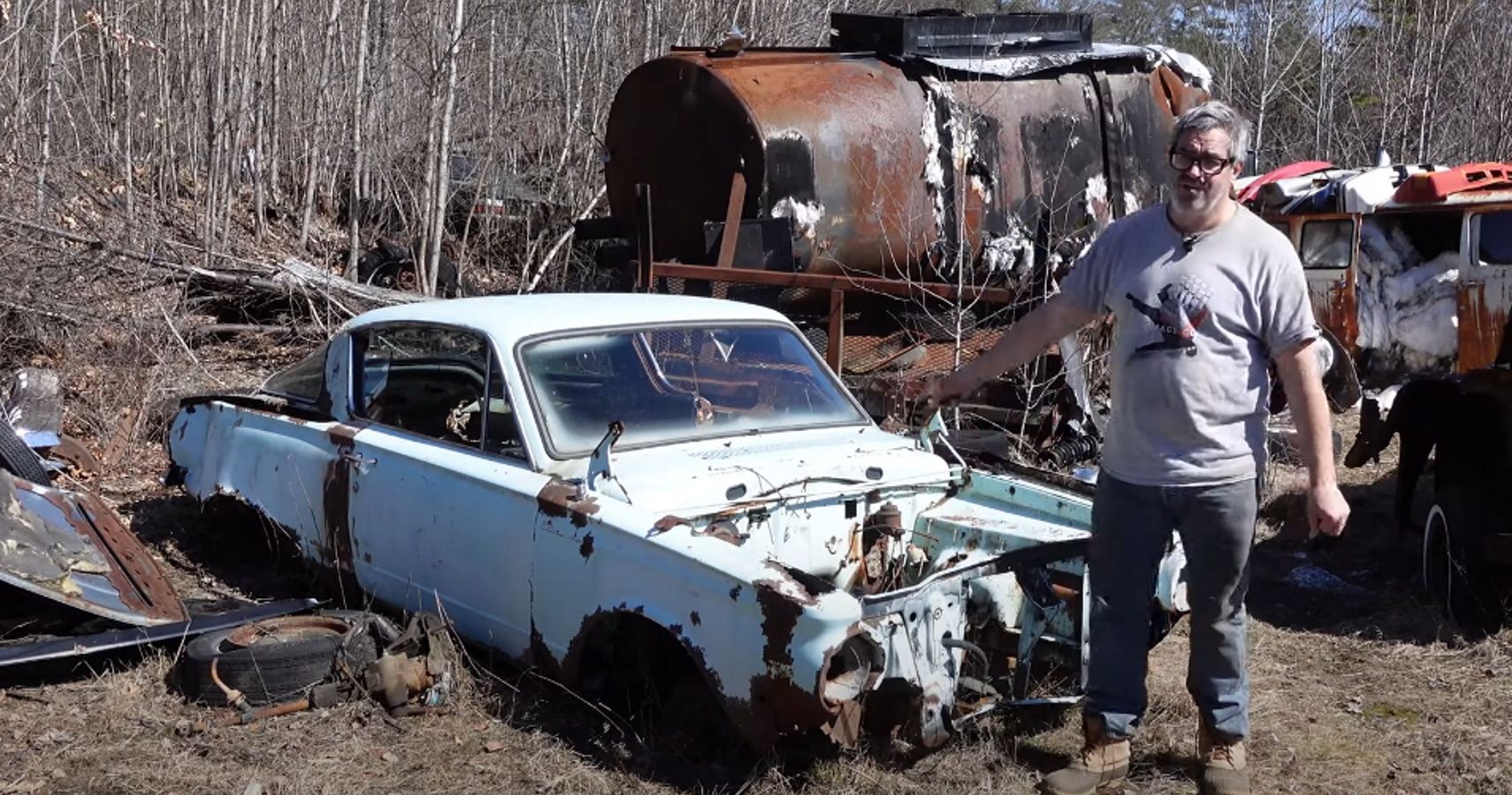 Steve Mangnante with a junkyard 1964 Plymouth Barracuda