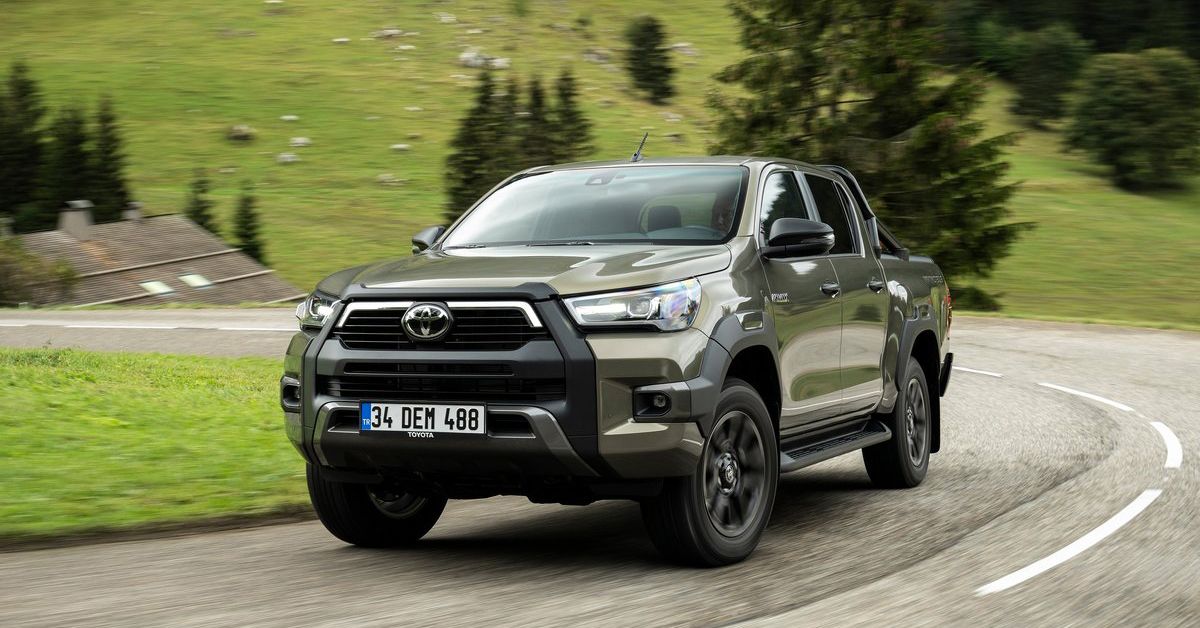 Titan bronze Toyota Hilux driving in the countryside