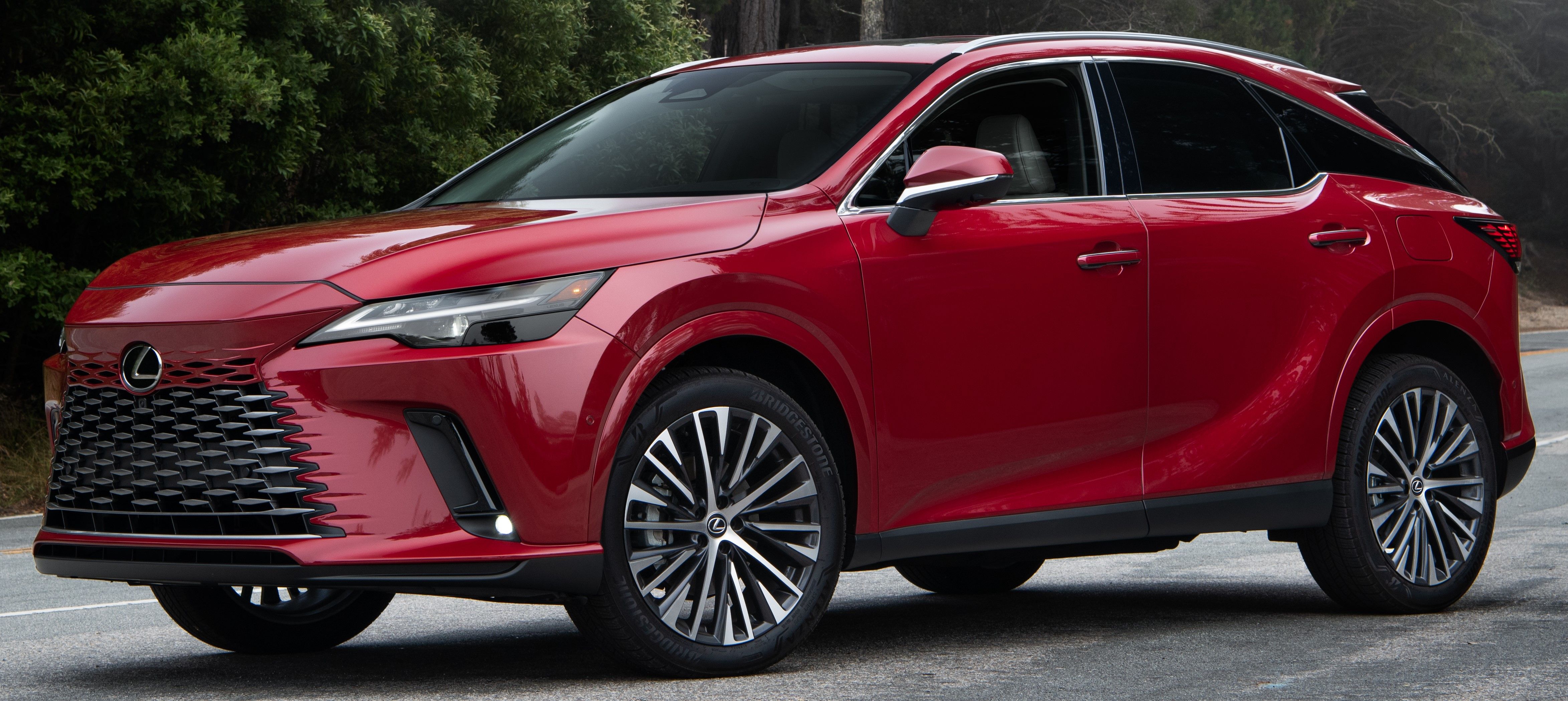 Red ​​​​​​​2023 Lexus RX 350h parked outdoors on the road