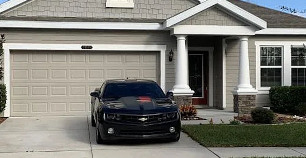 Chevy Camaro in front of house Via Zillow