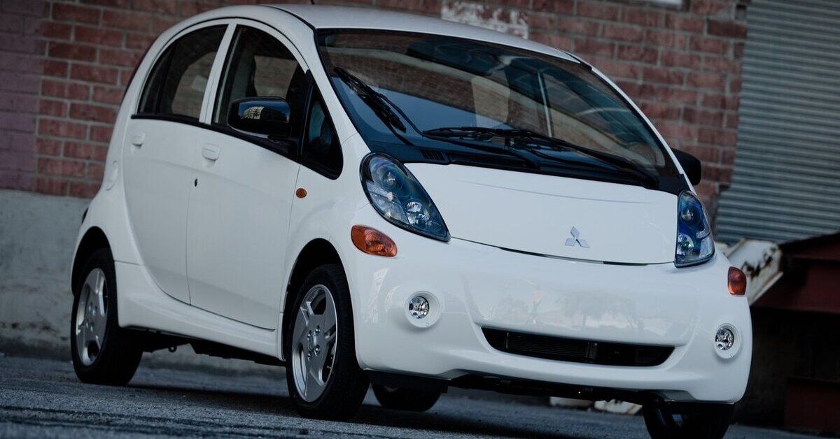 A white 2012 Mitsubishi i-MiEV parked