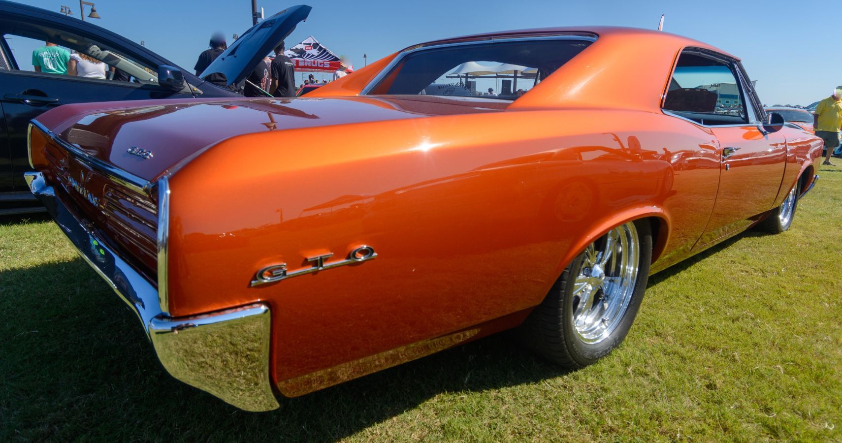 Orange Pontiac GTO On Grass At Car Show