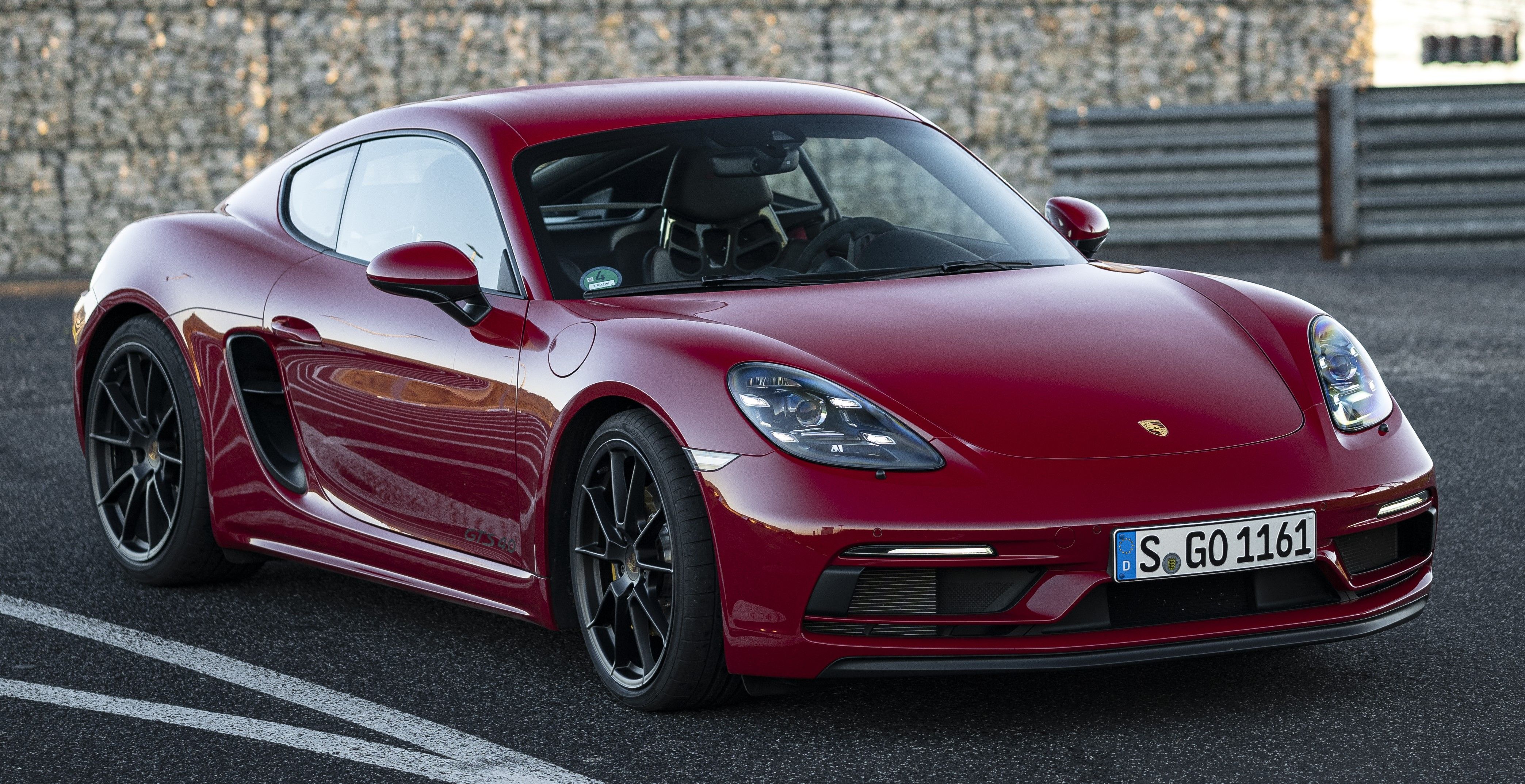 Red Porsche 718 Cayman parked on the track
