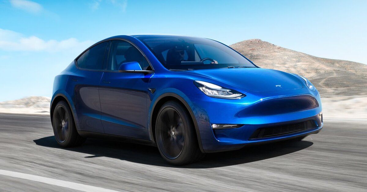 A blue 2021 Tesla Model Y driving 