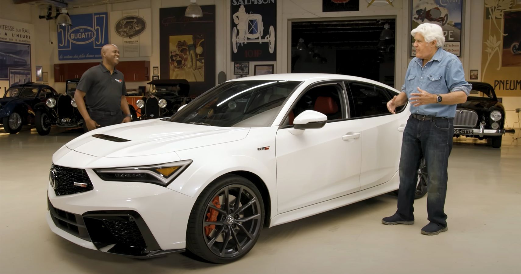 White Acura sports sedan with Jay Leno