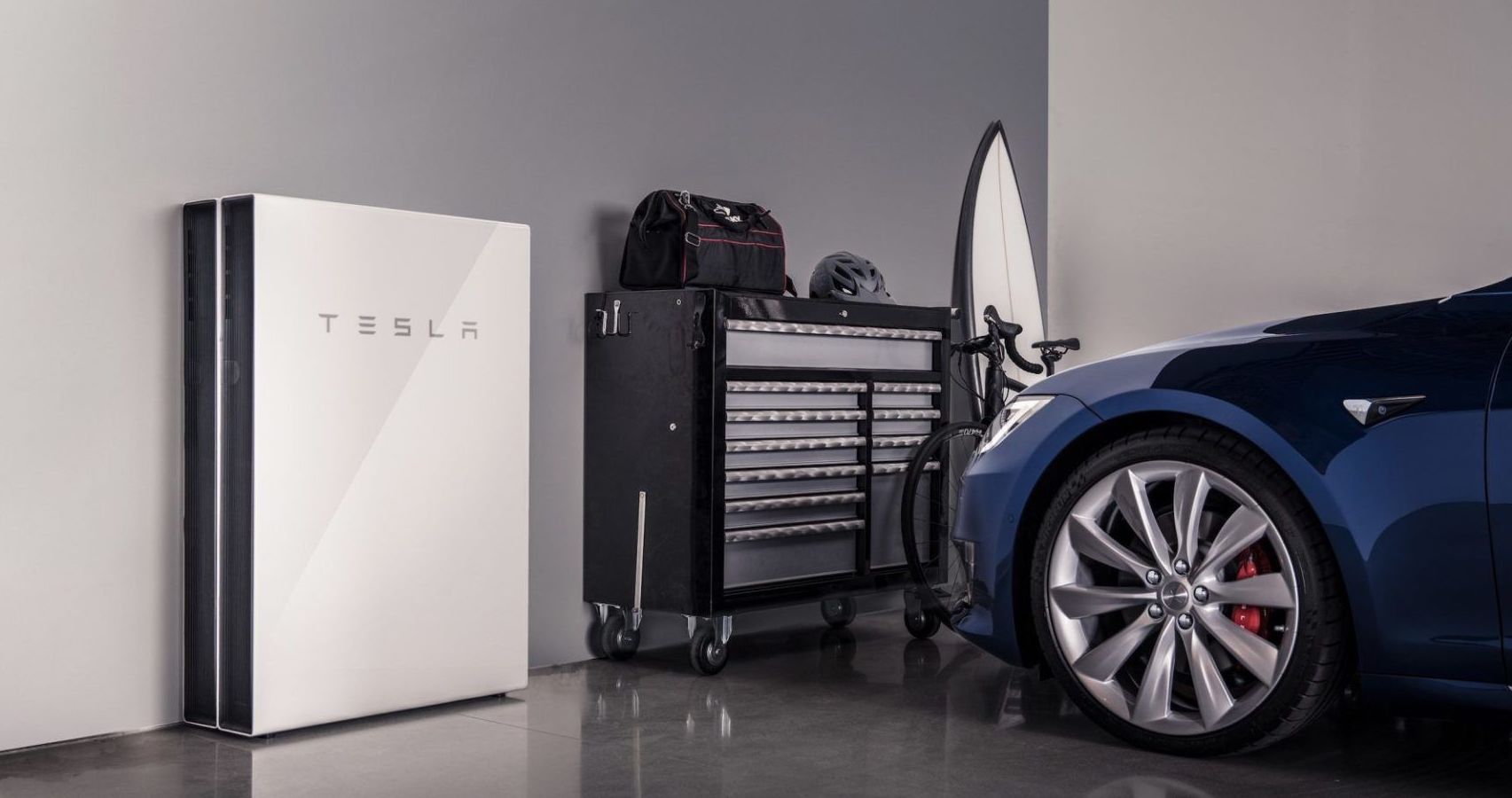 Tesla Powerwall 2 installed in a garage with tesla model 3 in blue