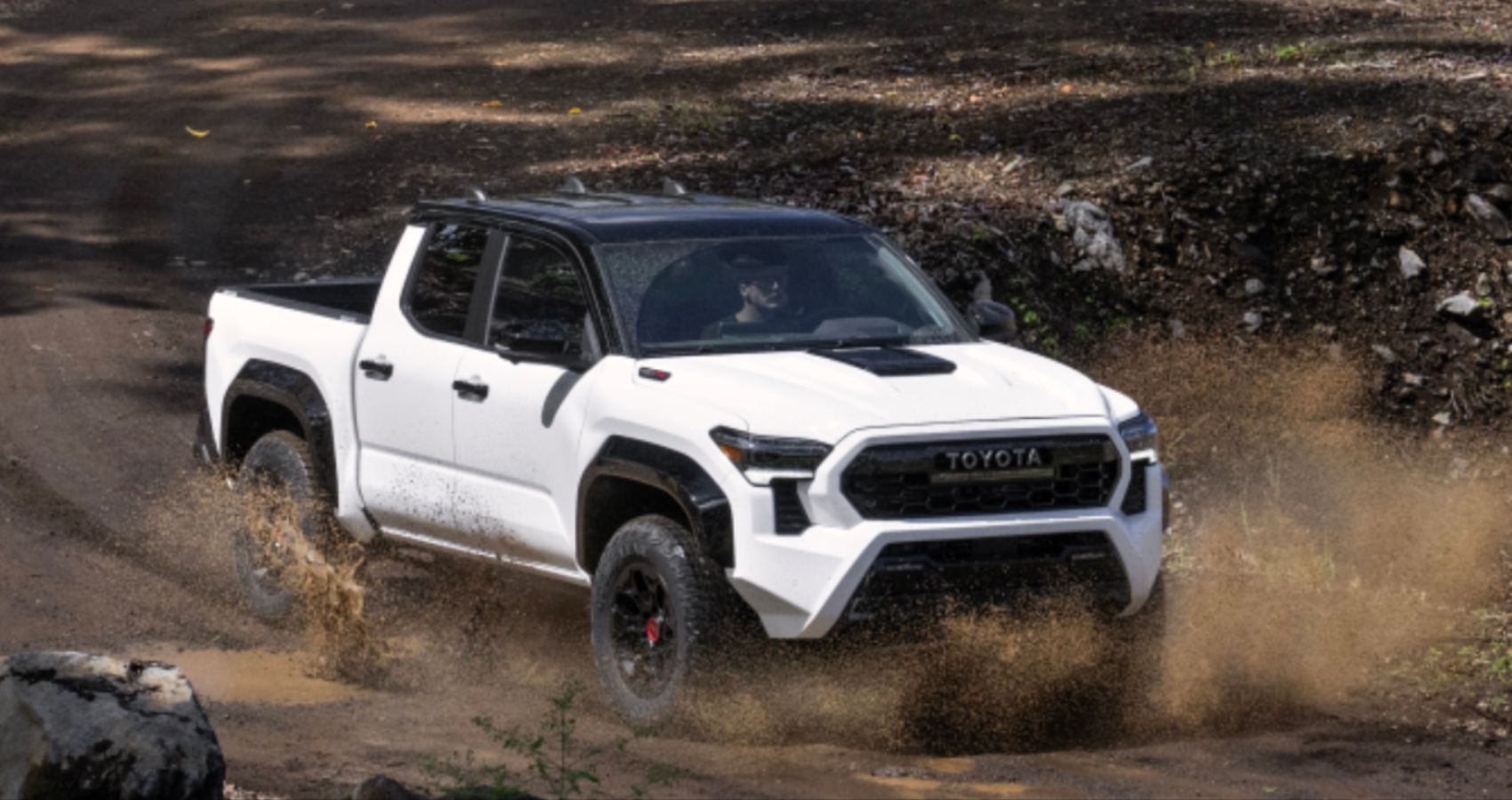 The 2024 Toyota Tacoma TRD Pro Running Down A Dirt Path