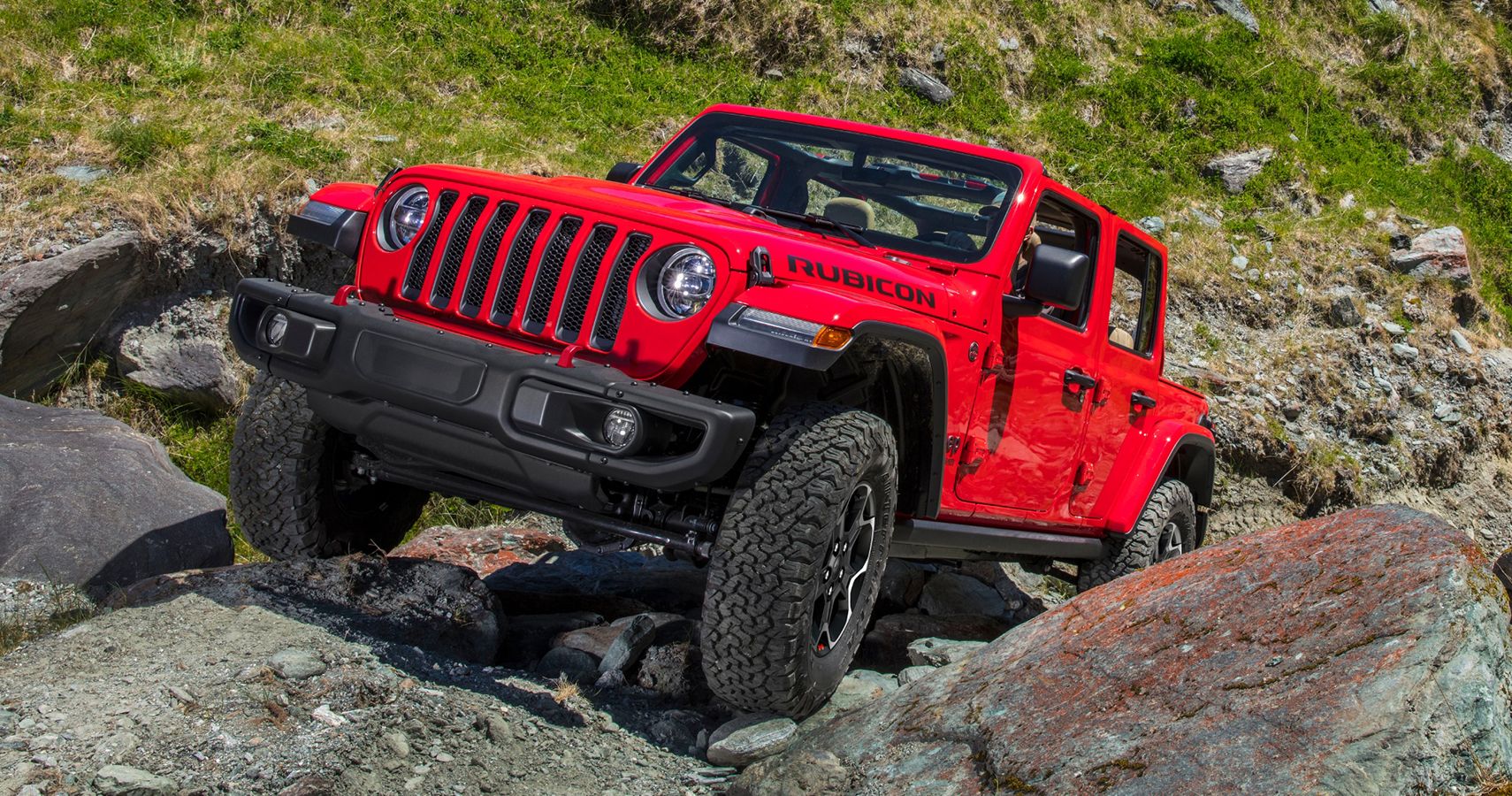 red Jeep Wrangler Rubicon quarter front off-roading