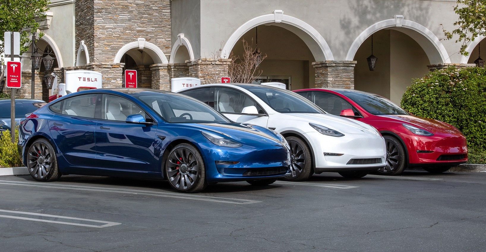 Tesla Model 3 cars parked outdoors and charging