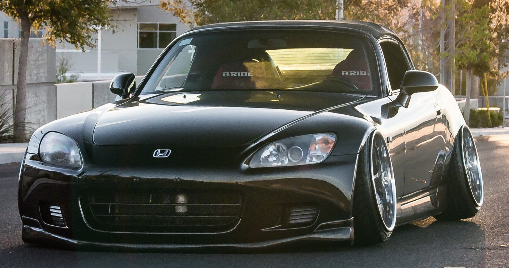 Stanced Honda S2000 on the road front third quarter view