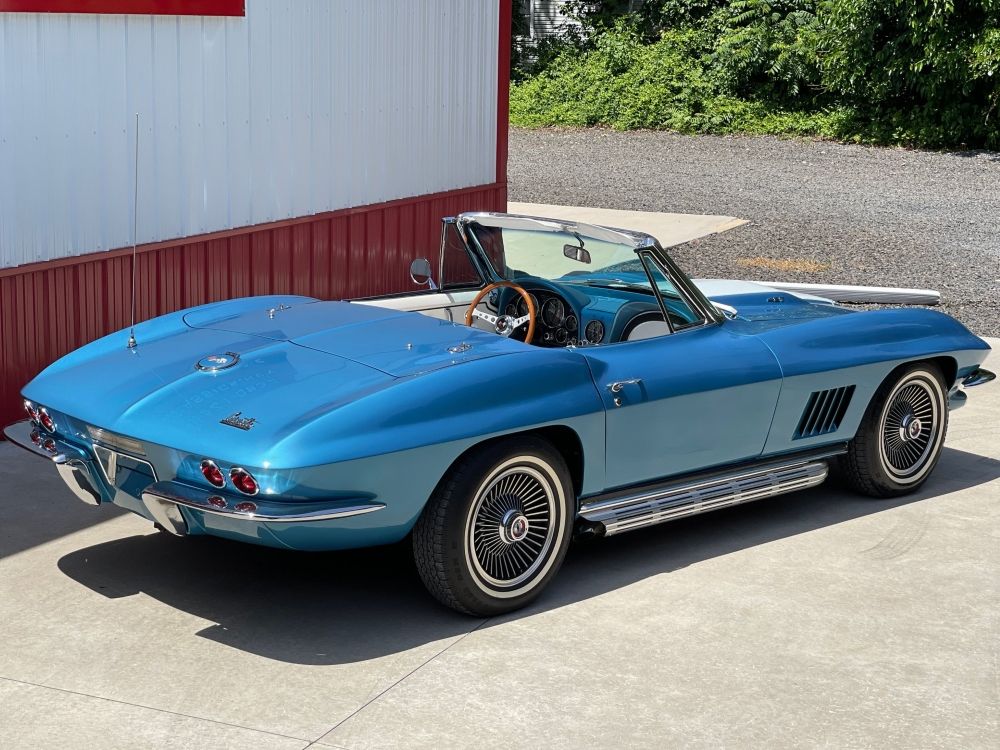1967 blue Corvette Sting Ray captured from the back with the roof unattached.