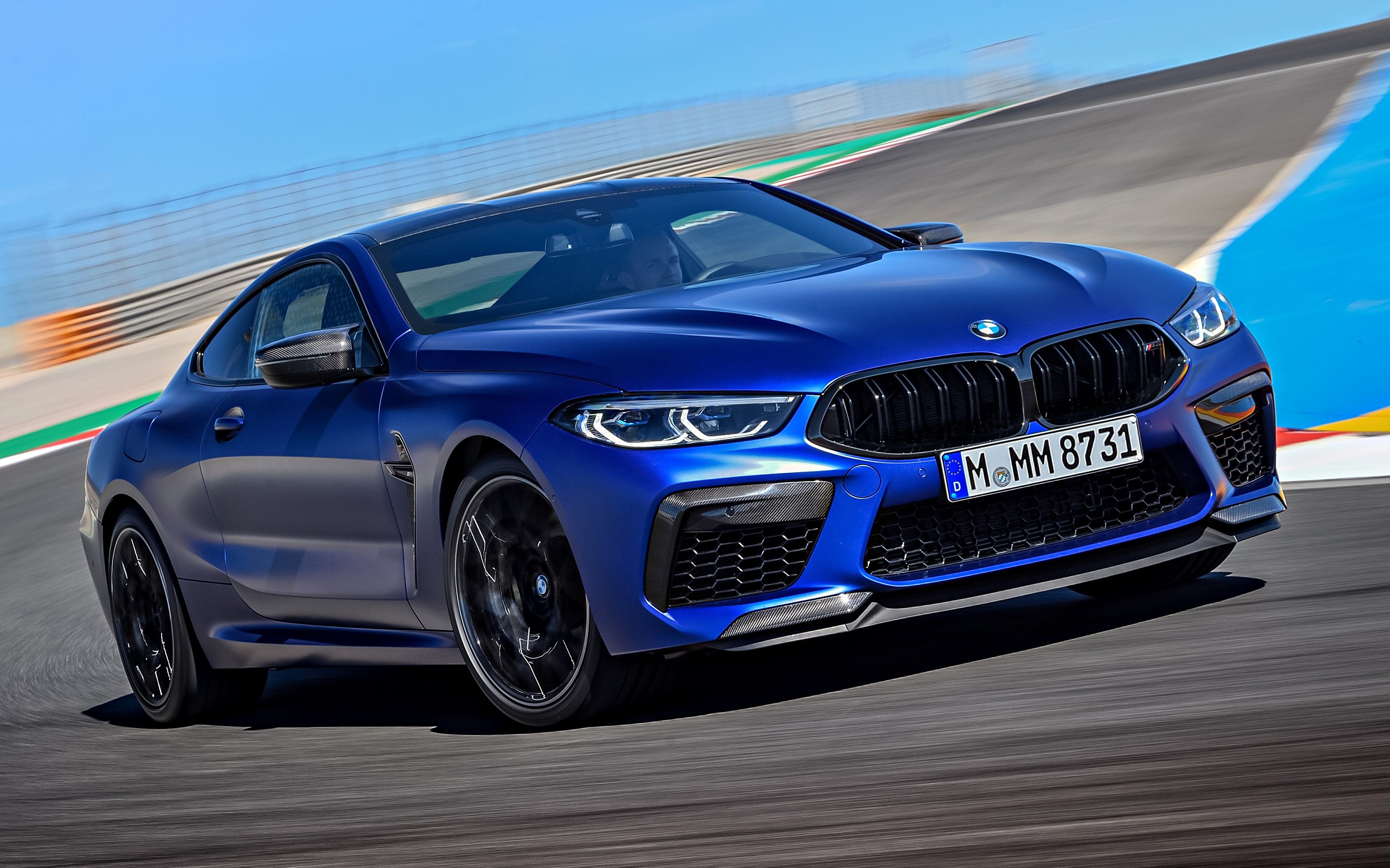Blue 2024 BMW M8 Competition driven on the track