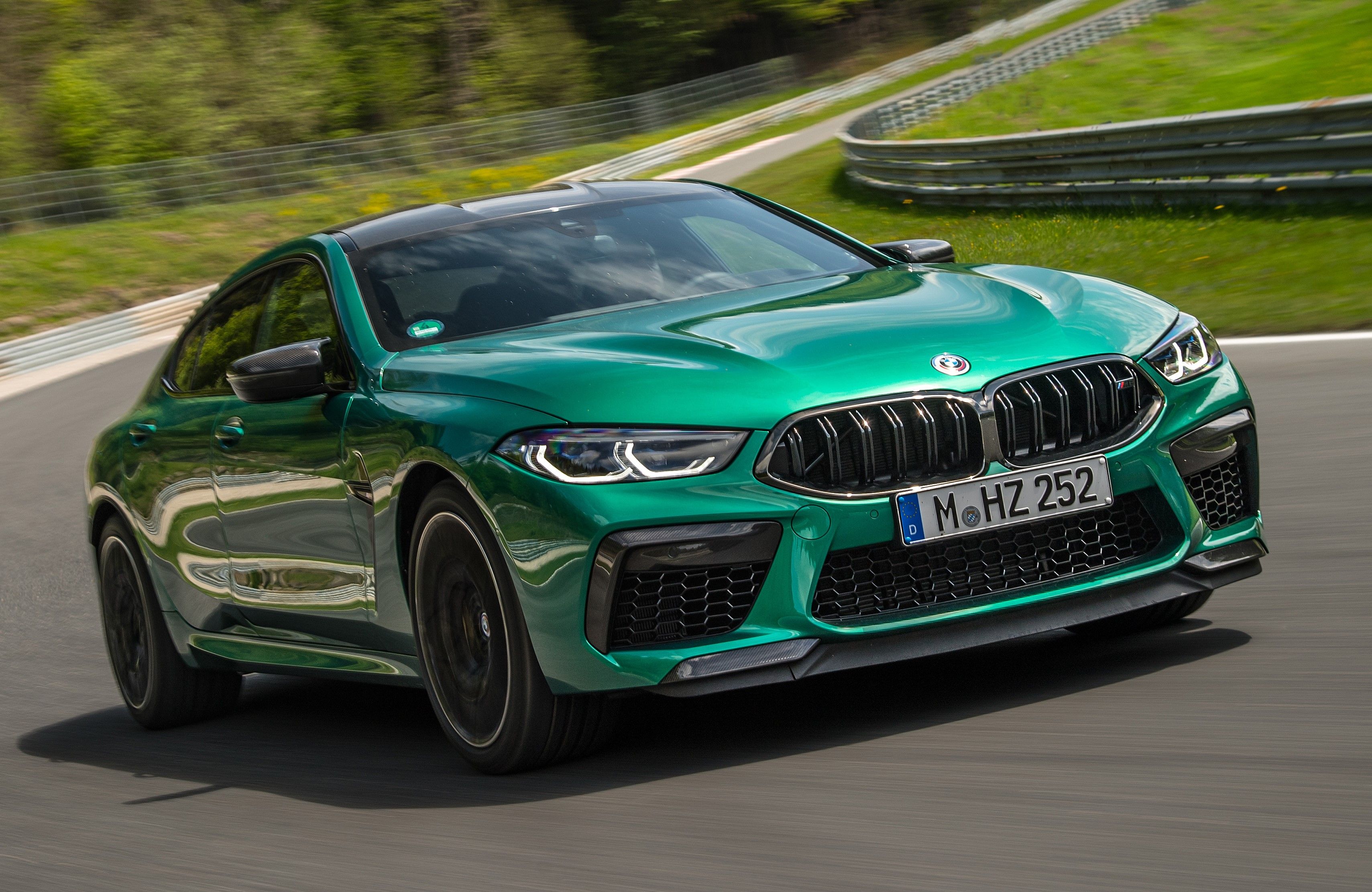 Green 2024 BMW M8 Competition Gran Coupe driven on the track