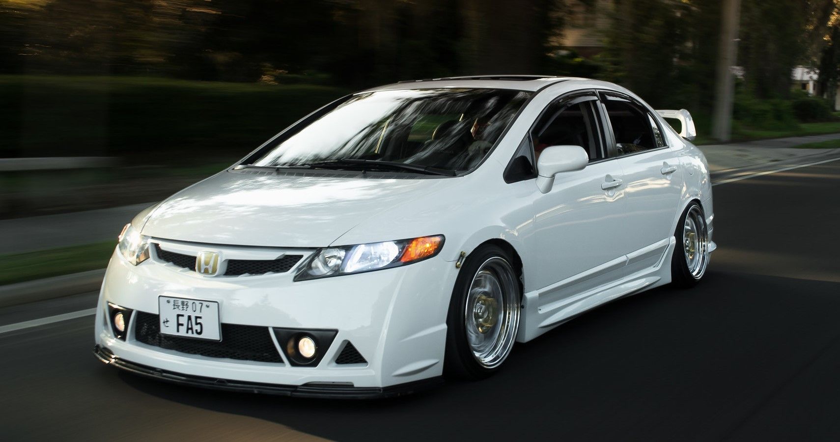 Stanced Honda Civic on the road front third quarter view