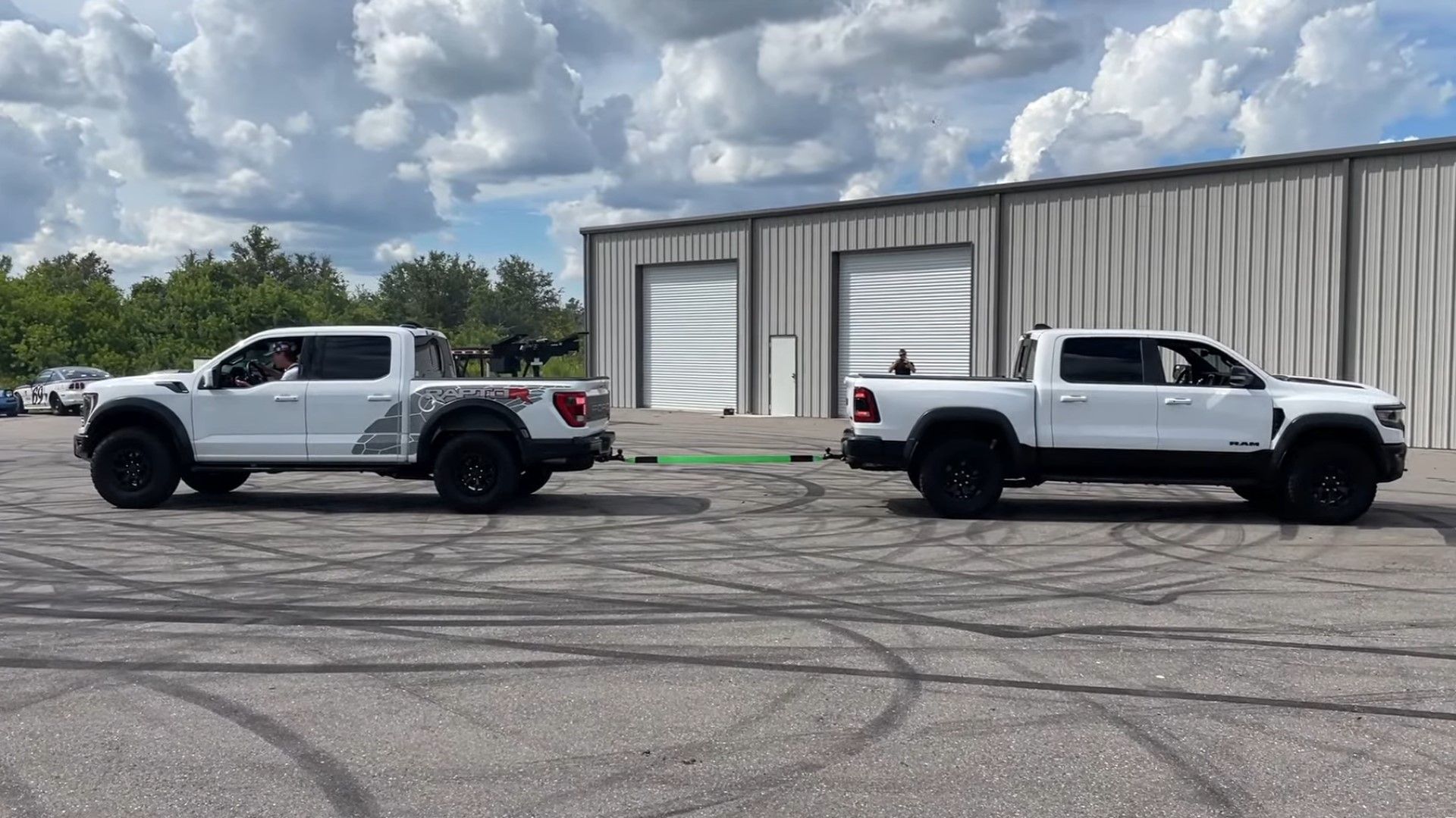 2023 Ram 1500 TRX / 2023 Ford F-150 Raptor R tug of war, both cars pulling in opposite directions