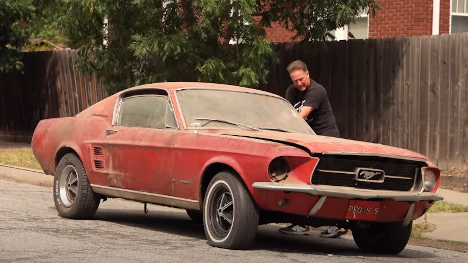 Dennis Collins with a 1967 Ford Mustang Fastback