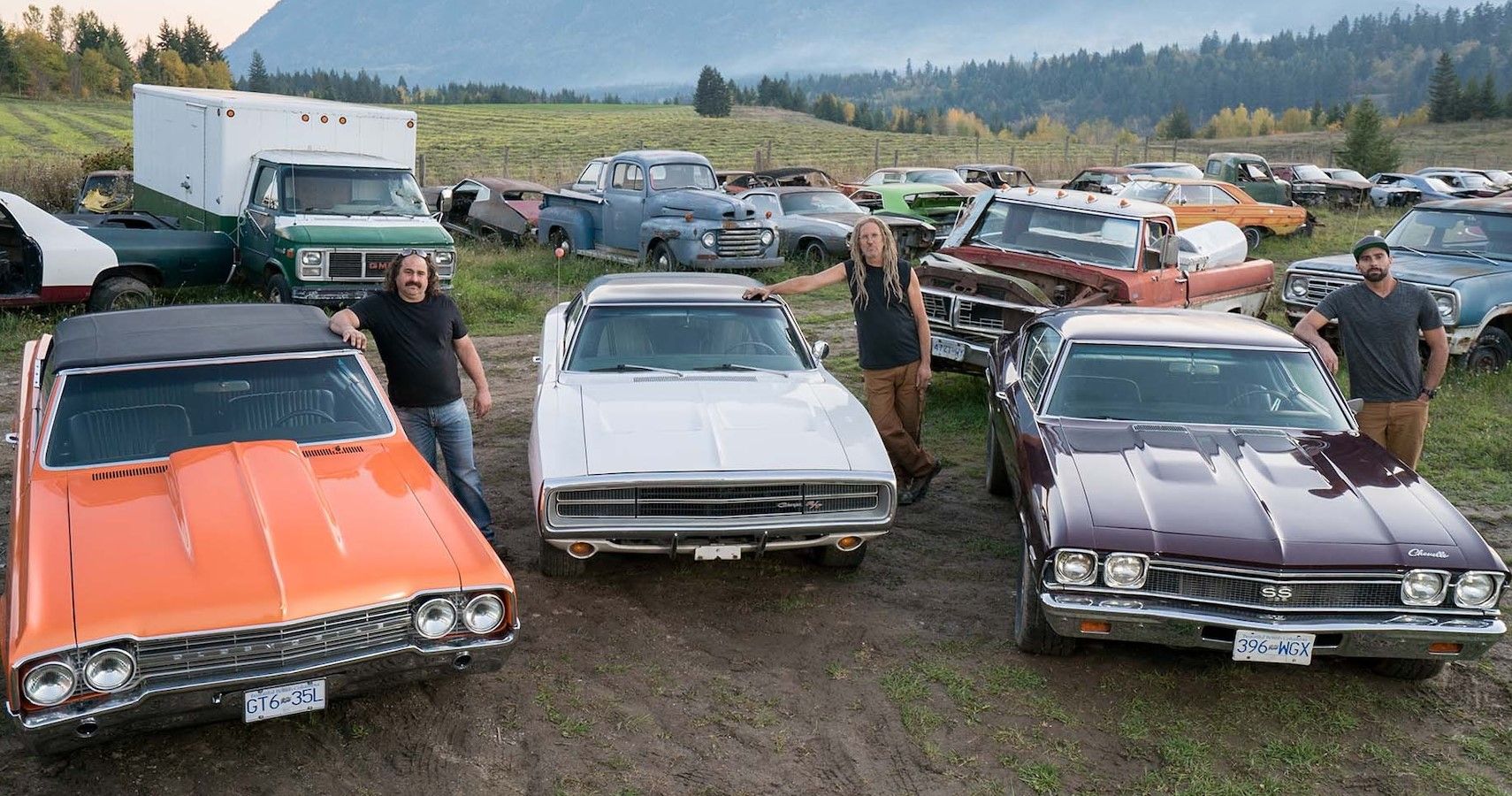 Mike Hall with his empire of rusty classic cars, trucks, and other cool vehicles