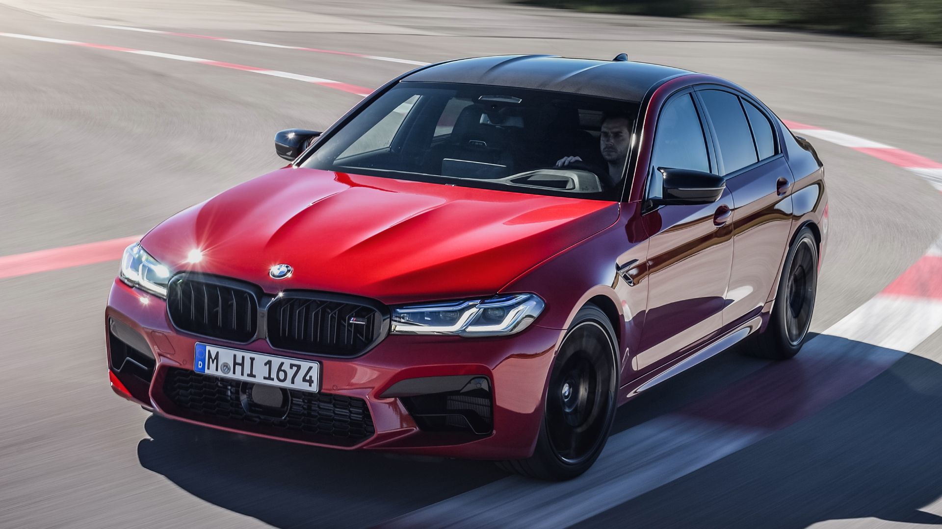Red 2023 BMW M5 driven on the track