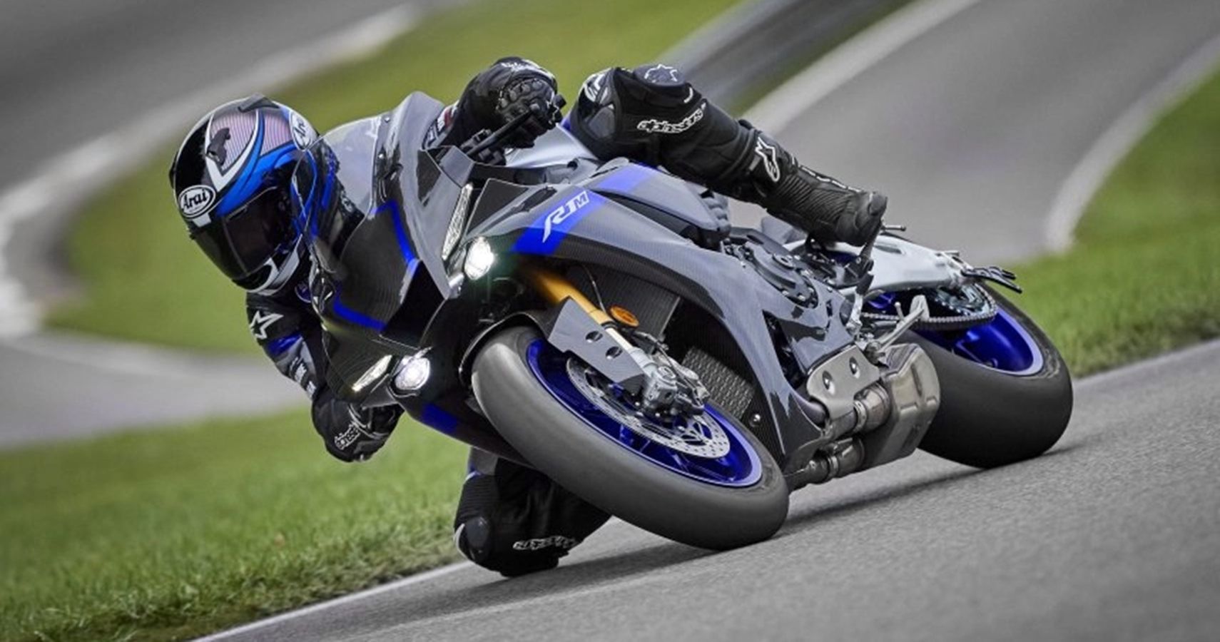 Black and blue Japanese motorcycle turning on track