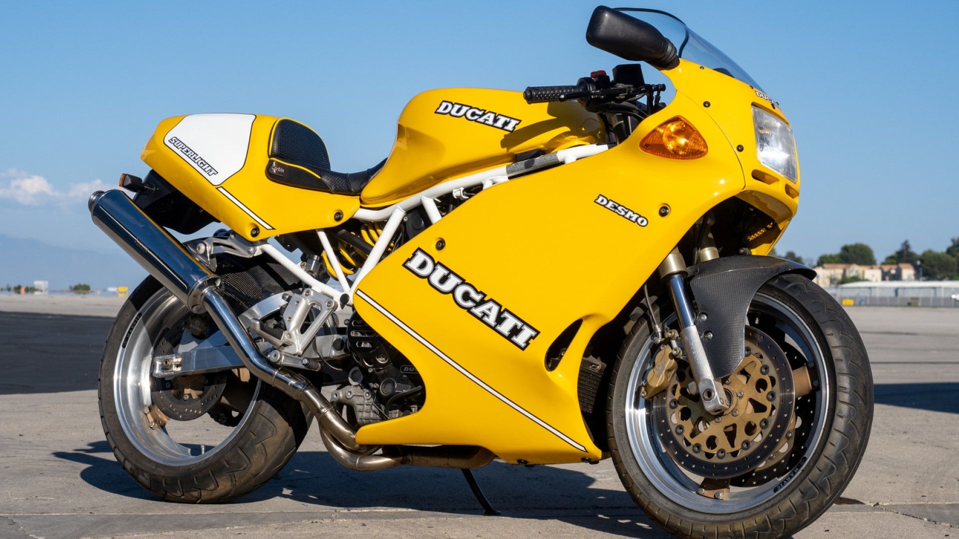 Ducati 900 Superlight in yellow side profile view