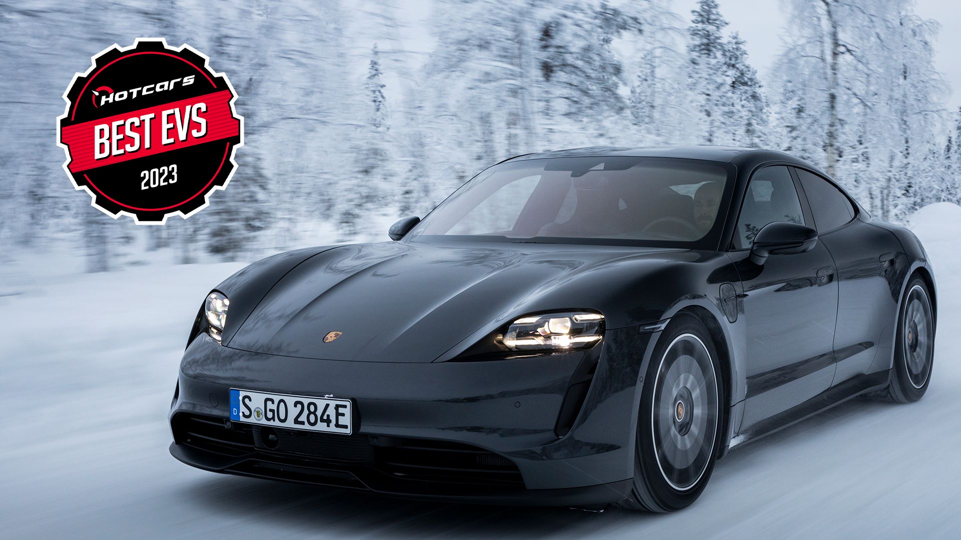 Black Porsche Taycan 4S driving on snow