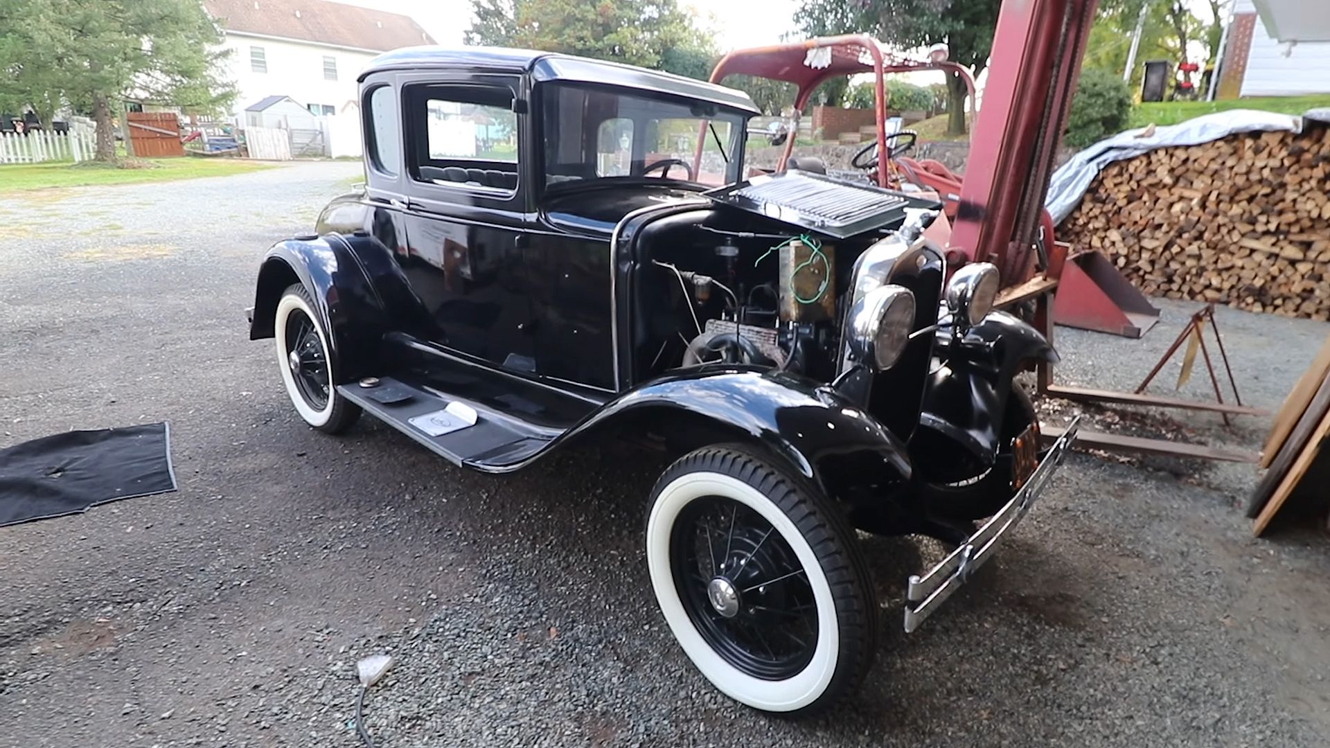 Black 1931 Ford Model A with open hood ready for restoration