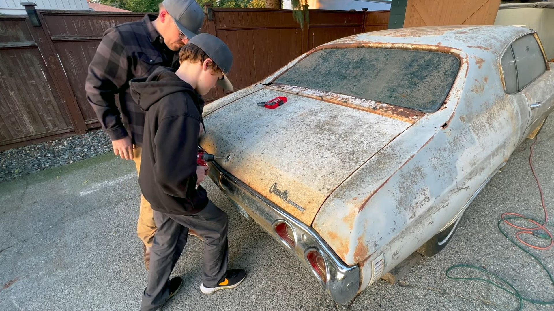 A white and rusted Chevrolet Chevelle Malibu 350 barn find
