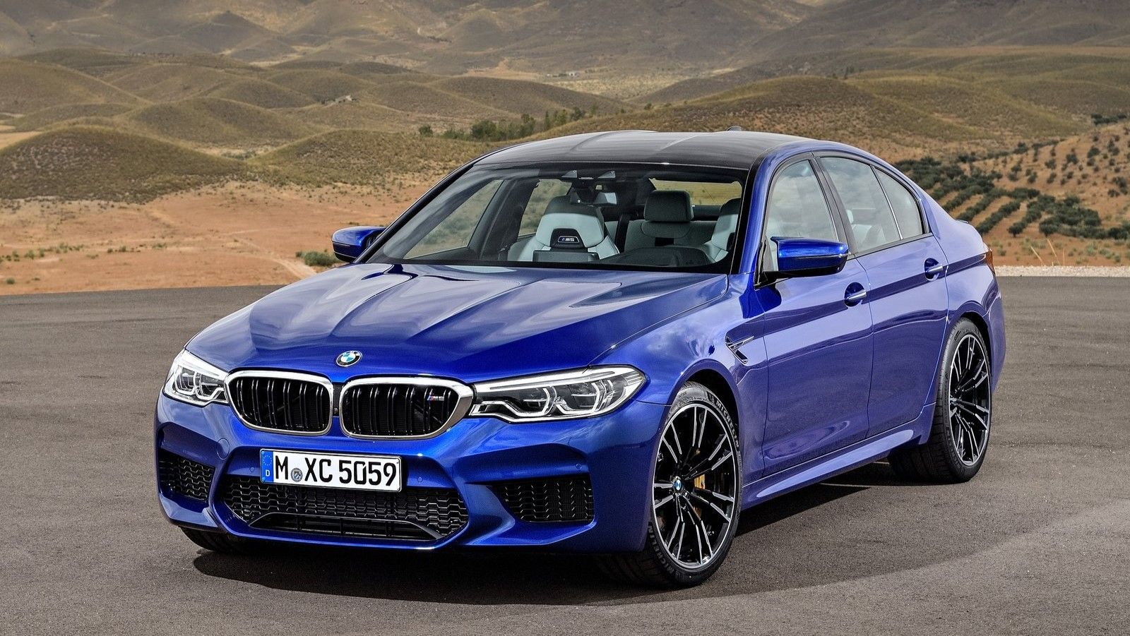 2018 BMW M5 CS parked in an empty lot.