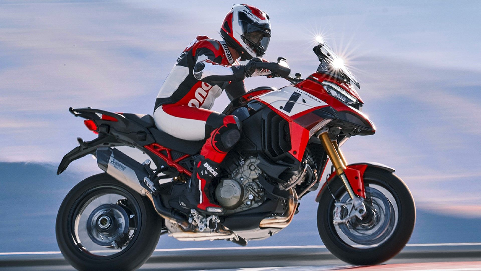 Ducati Multistrada V4 Pikes Peak accelerating wildly while popping a wheelie side profile view