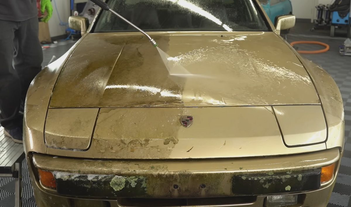 Gold Porsche 944 being cleaned