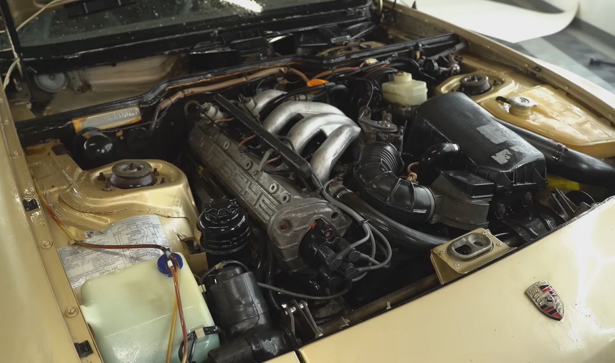 The gold Porsche 944 engine is cleaned