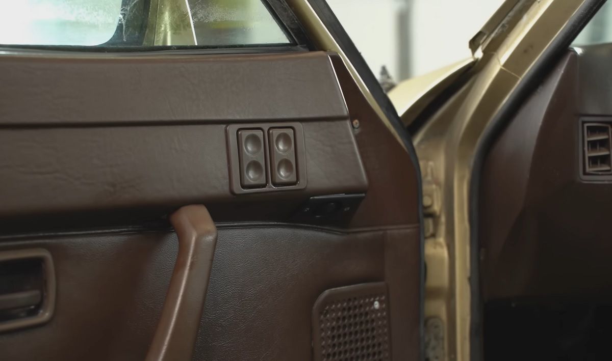 The interior of the gold Porsche 944 is being cleaned